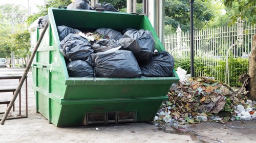 Waste clearance truck servicing a construction site in Tooting